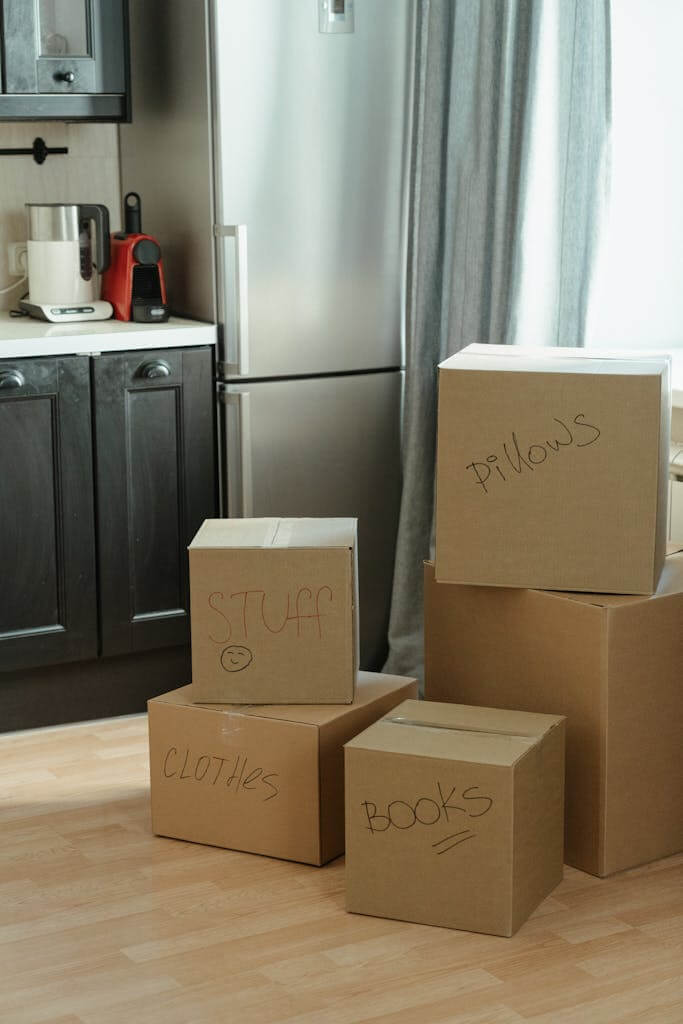 Brown Cardboard Boxes on White Wooden Cabinet